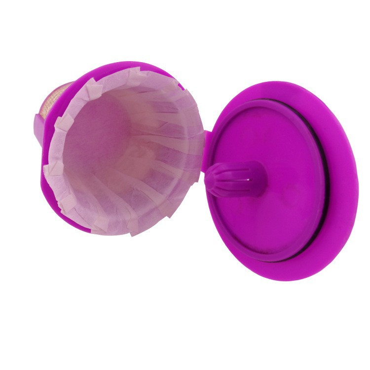Purple silicone cupcake liner with a clear plastic liner on a white background