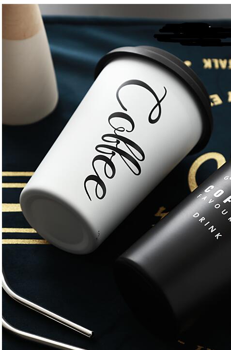 White travel mug with 'Coffee' text on a dark surface